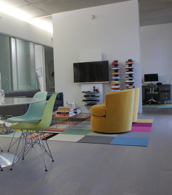 a dining room with a table and chairs and a television at Lofts at 629, Ohio, 44114