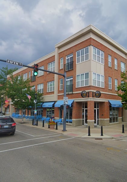a building on the corner of an intersection with a traffic light at Monmouth Row Apartments, Newport, 41071