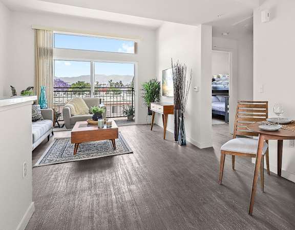 a living room with a large window and a balcony
