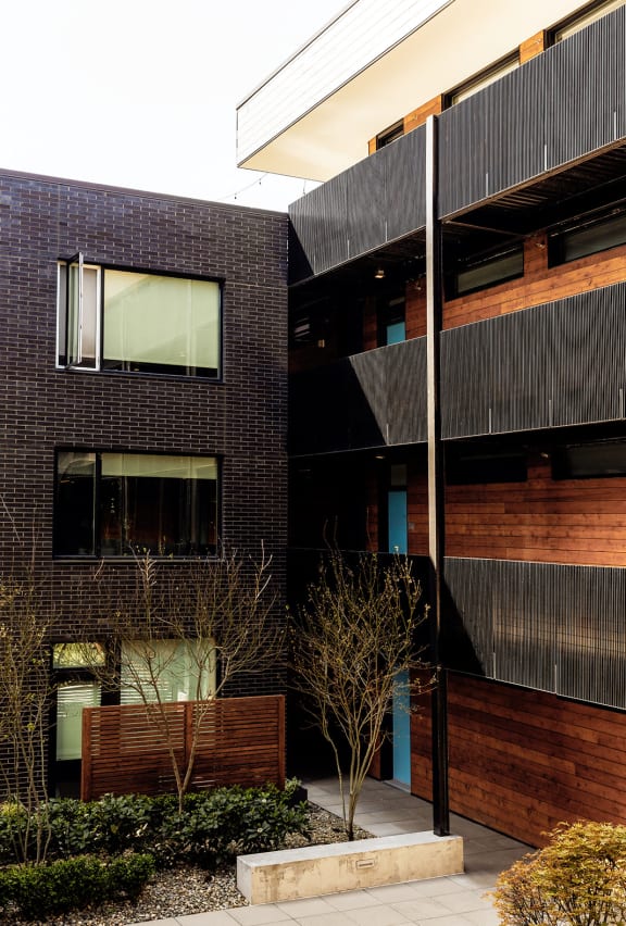a black building with a courtyard in front of it