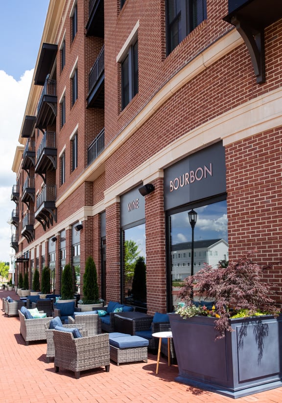 a large brick building with a patio outside of it at Lyric at Norton Commons Apartments, Prospect, Kentucky