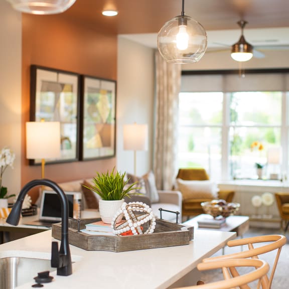 a kitchen with white cabinets and a wooden table at The Yards at Malvern, Malvern, PA