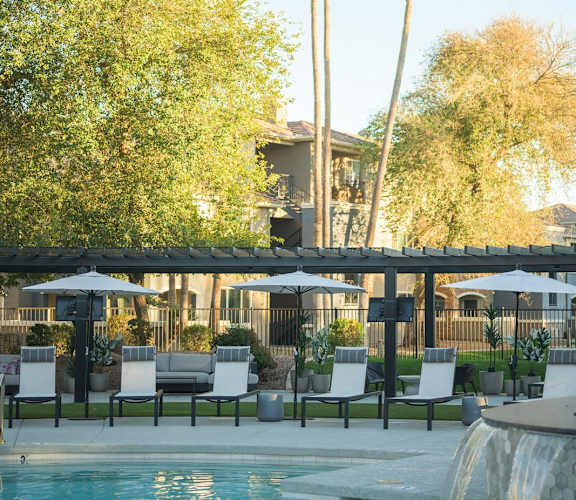 a swimming pool with palm trees in the background