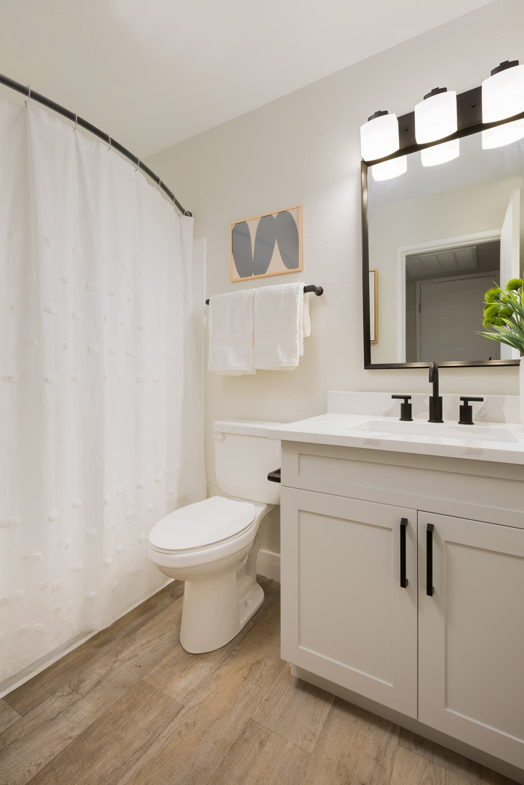 Apartment bathroom — representative home at Reveal.