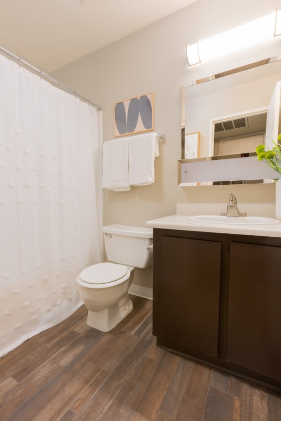 a bathroom with a toilet sink and shower