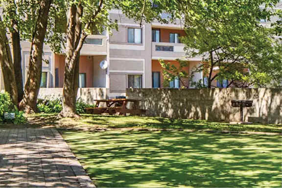 A building with a green lawn in front of it.