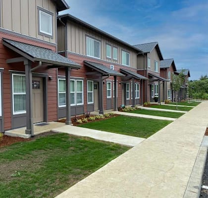 A row of houses with brown and grey siding.