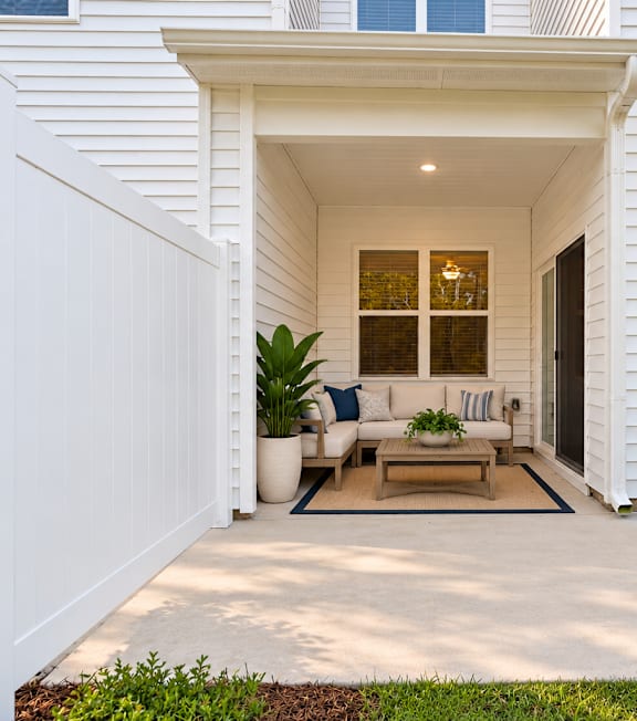 A white house with a covered patio area.