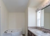 Thumbnail 10 of 18 - a bathroom with a bathtub and a sink