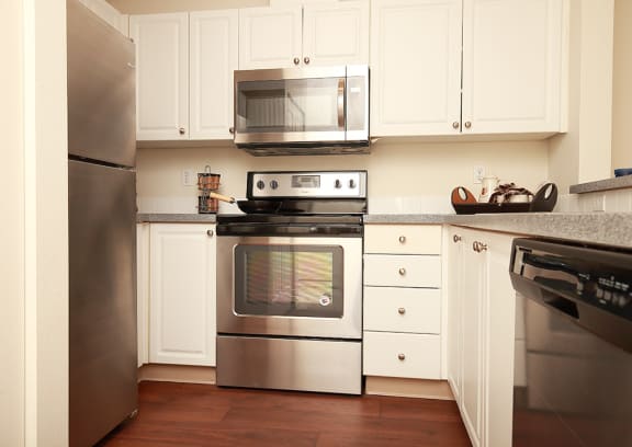 Kitchen with Stainless Steel Appliances at Burnett Station Apartments Renton, WA