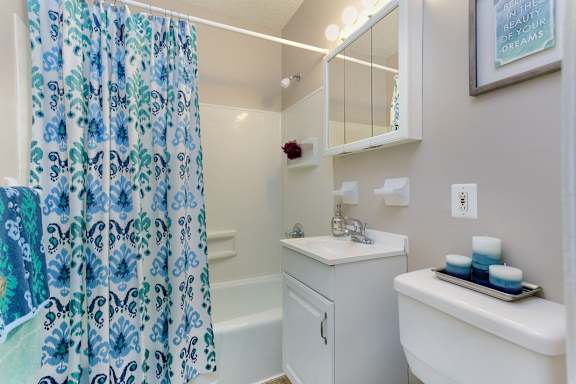 A small white bathroom with a white sink and a white toilet at Rose Hill Estates, Norwich, CT, 06360