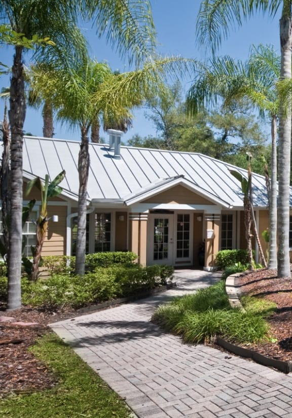 a building with stairs and palm trees in front of it