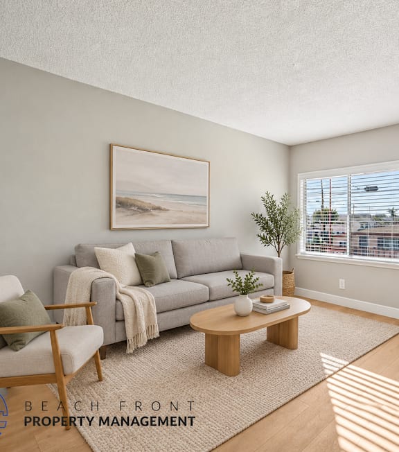 A well-lit, modern kitchen and living room with a dining area.