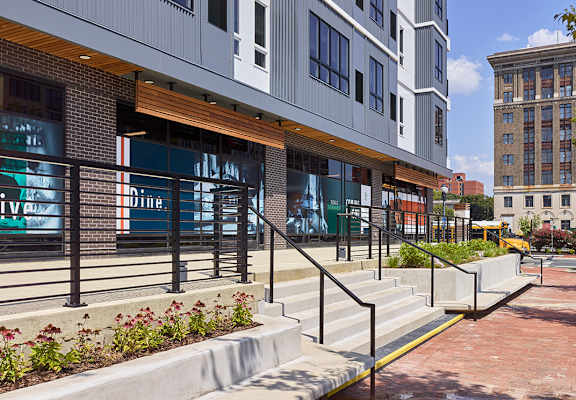 A modern building with a glass entrance and a metal railing. at 11 Cooper Apartments, Camden, New Jersey, 08102