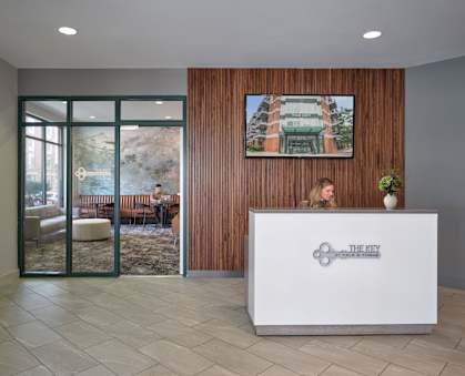 A reception area with a woman behind the desk.
