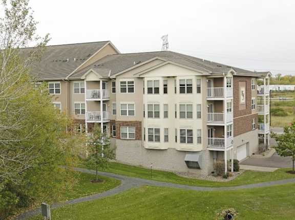 Apartment complex with a green lawn in front.