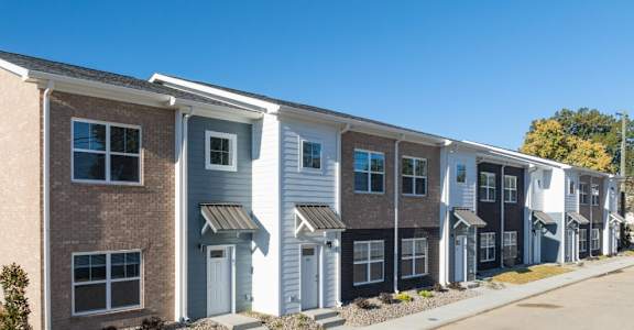 A row of townhouses with different colored exteriors.