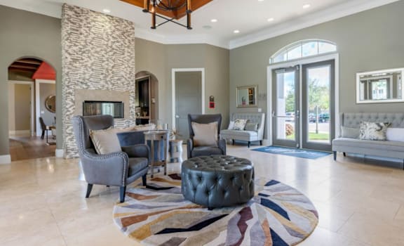 a living room filled with furniture and a stone wall