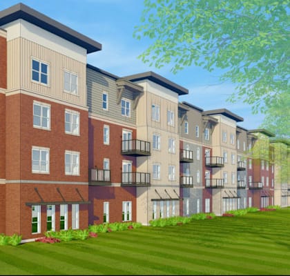 a rendering of a three story apartment building with a green lawn