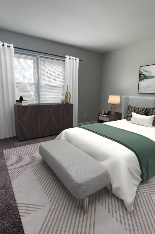 a bedroom with a bed and a rug