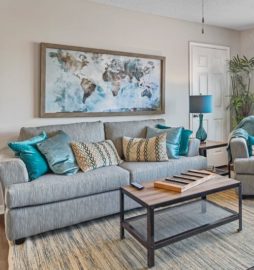 a living room with a couch and a chair and a table