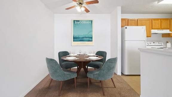 One-Bedroom Apartments in Wadsworth, OH - Stratford Crossing - Dining Area with a Circle Table, Ceiling Fan, and Kitchen Area