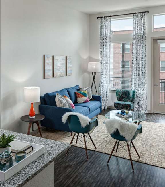 A blue and black circular logo with wavy lines at Regatta Sloans Lake Apartments, Colorado, 80204