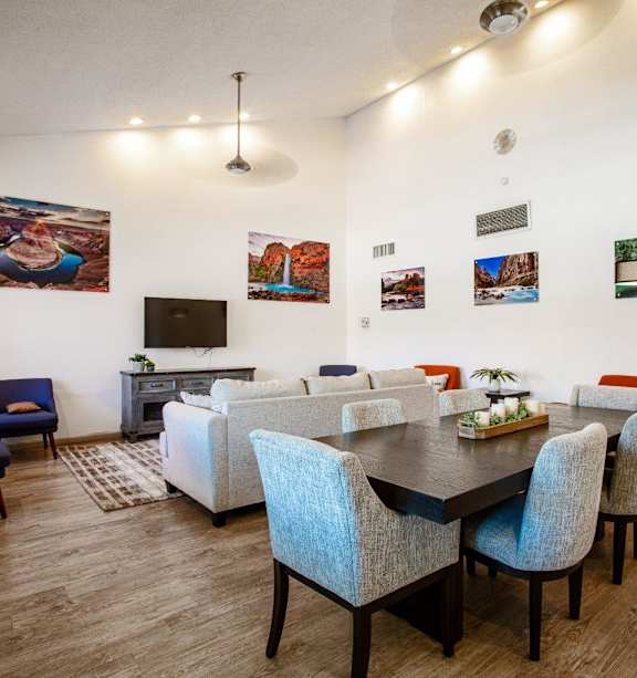 A living room with a dining table and chairs.