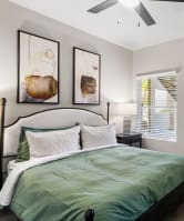 a bedroom with a bed and pillows