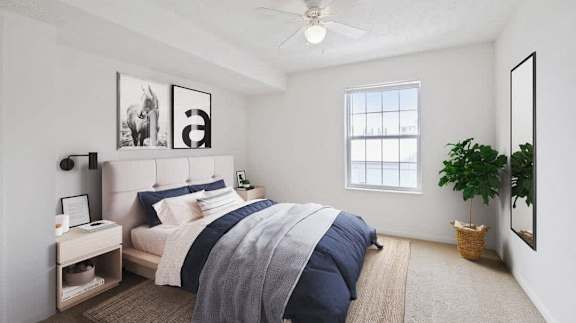 an image of a bedroom with a bed and a ceiling fan