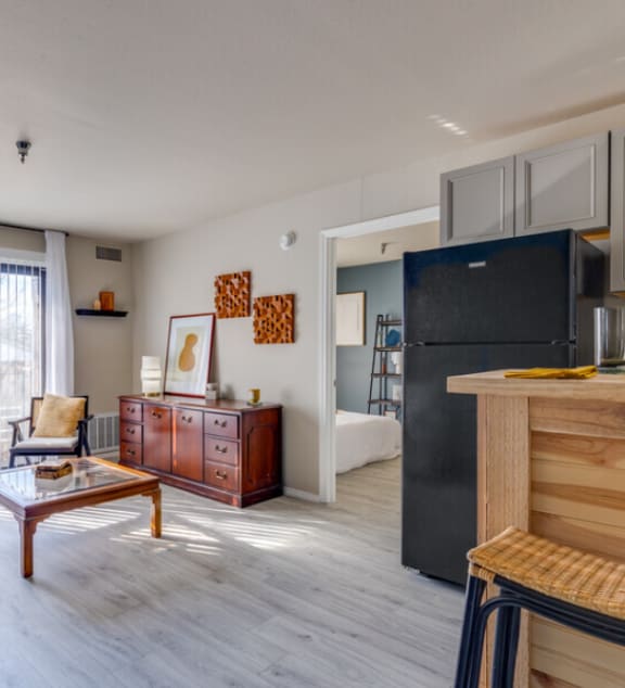 a kitchen with a black refrigerator freezer next to a stove top ovenat The Lodge Apartments, Tulsa, 74129