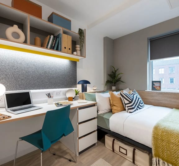 a bedroom with a bed and desk in a 555 waverly unit