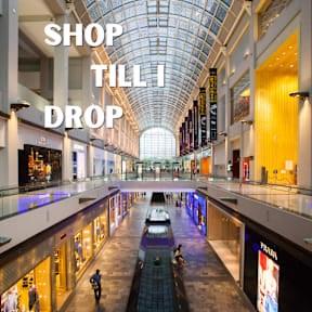A shopping mall with the words "SHOP TILL DROP" displayed.