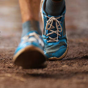a close up of a person wearing blue hiking shoes