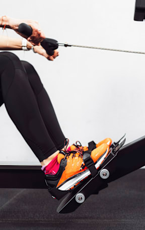 A person is exercising on a rowing machine.