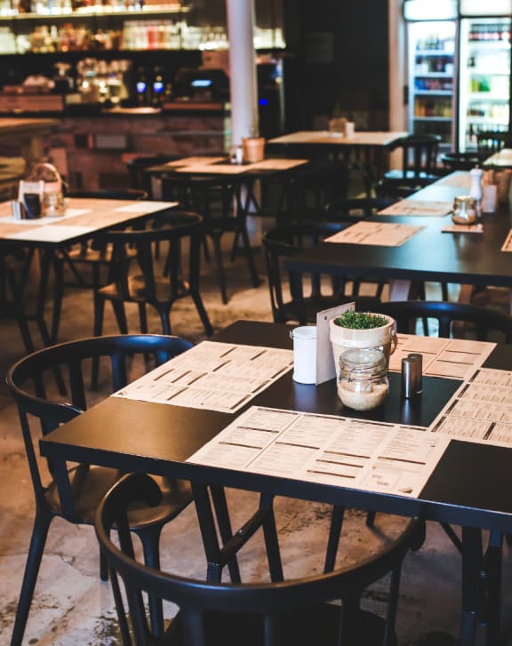 an empty restaurant with tables and chairs