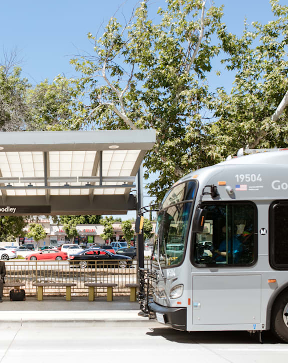 A bus with the number 19504 on the front is parked at a bus stop.