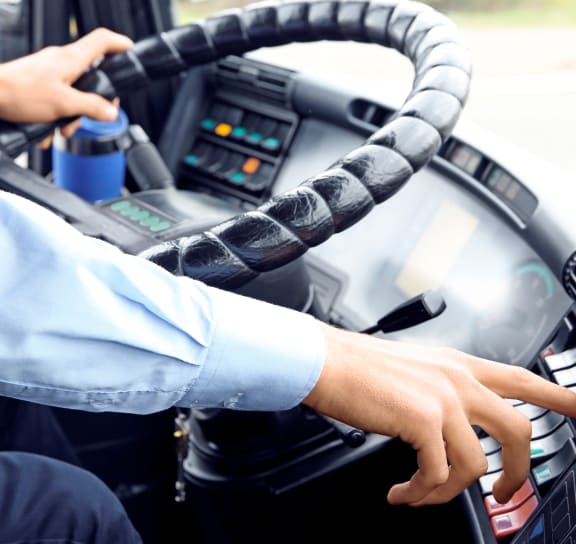 a man driving a car with his hands on the steering wheel