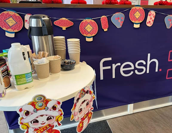 A table with a sign that says "Fresh" on it.