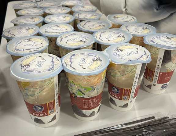 A table is covered with cups and straws.
