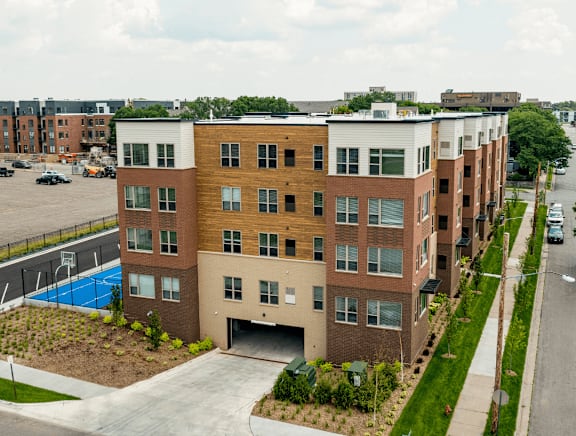 A modern apartment building with a pool in the backyard.