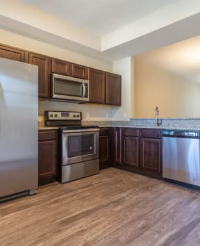 Large kitchen with stainless steel appliances at Playa Apartmtents