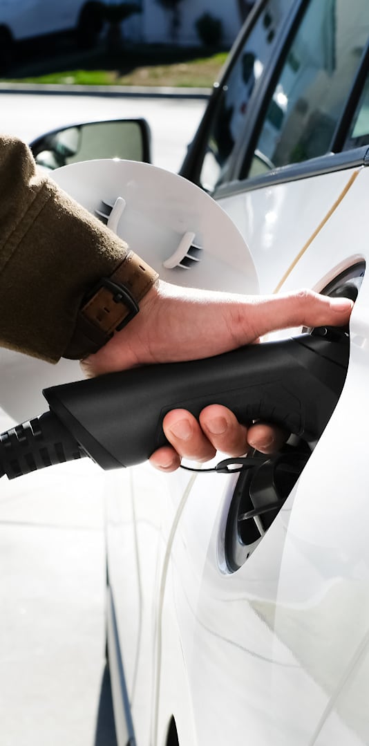 A person is charging an electric car.