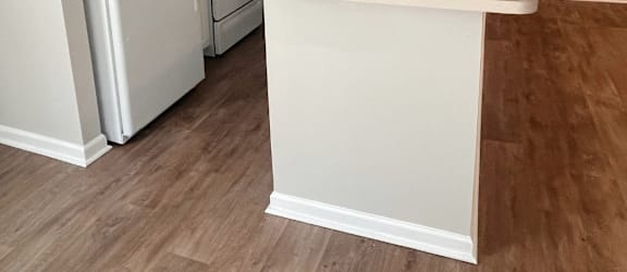 a kitchen with white cabinets and a white counter top