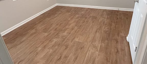 an empty room with hardwood floors