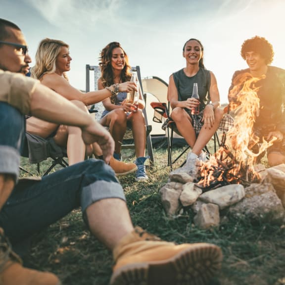 a group of people sitting around a camp fire at Red Bay Apartment Complex, Jacksonville, Florida
