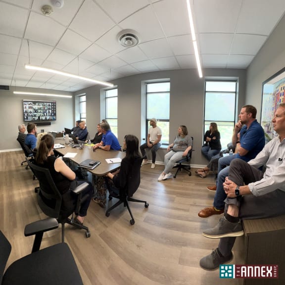 a group of people standing around a table
