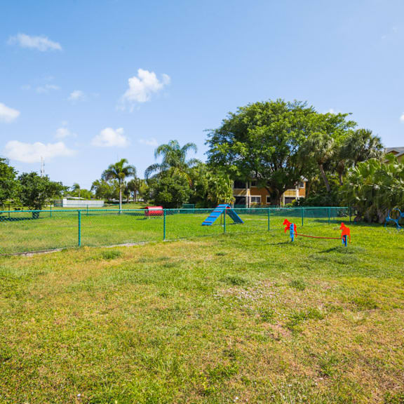 three children playing in a park at The Villages of Banyan Grove, Boynton Beach, FL, 33436