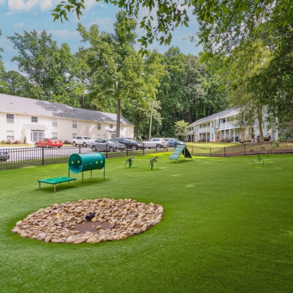 a park with a fire pit in the middle of a green yard at Lake Johnson Mews, Raleigh, NC