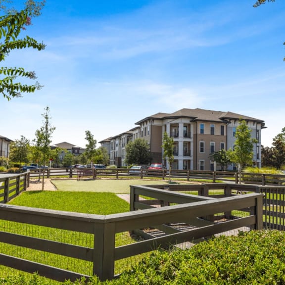 a park with benches and a building in the background